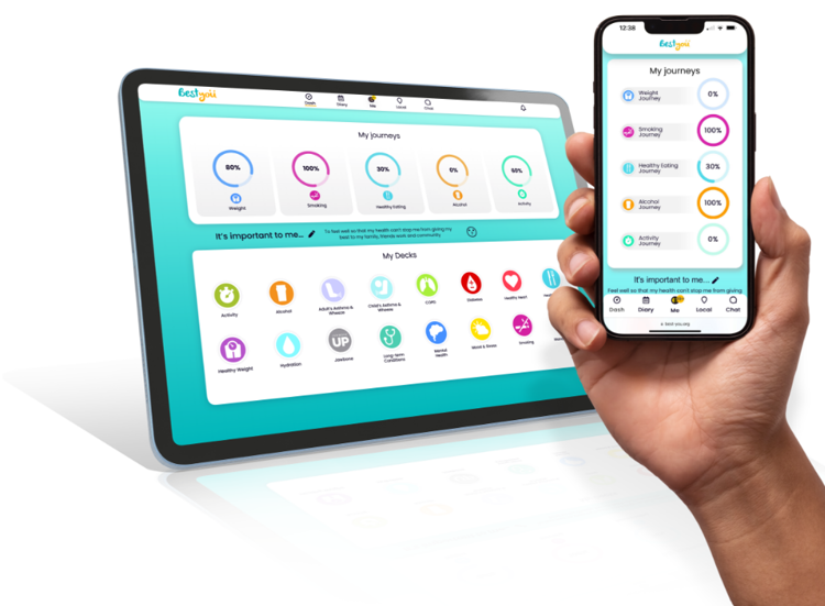 A mother and her 2 small children, she is holding the smallest baby in her arms whilst smiling, her elder child is smiling at the camera